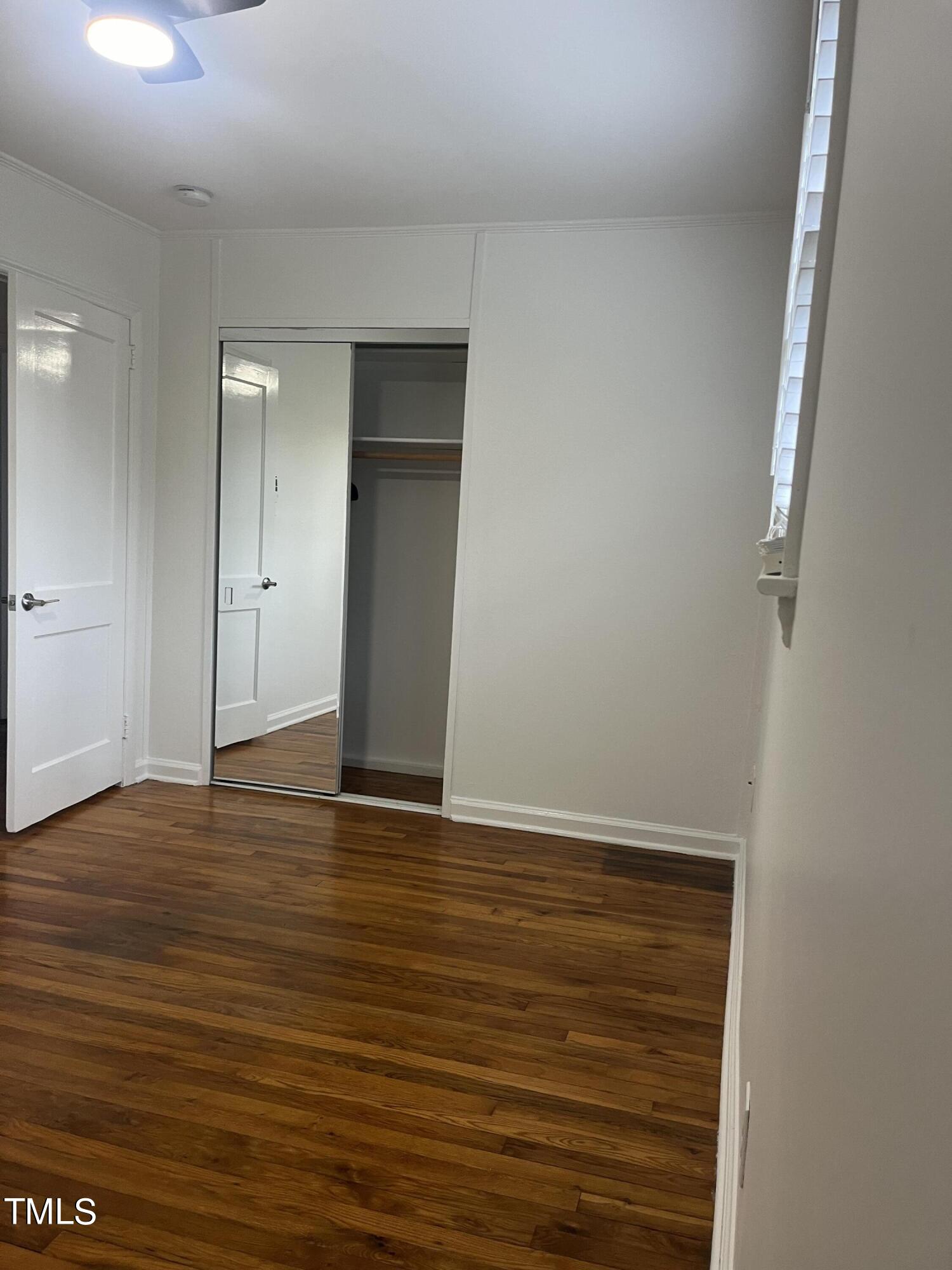 2626 McNeil Street Raleigh, NC 27608 - Photo 9 of 15 a view of an empty room with wooden floor and closet