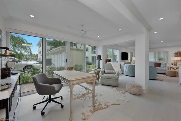 a living room with furniture and a potted plant
