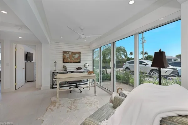 a living room with furniture a large window and a flat screen tv