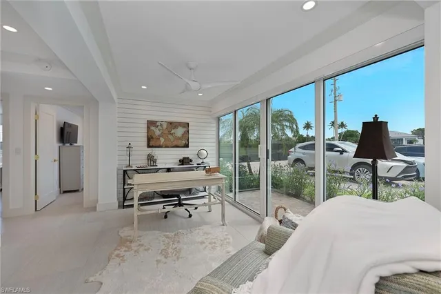 a living room with furniture a large window and a flat screen tv