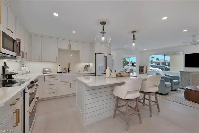 a kitchen with counter top space cabinets and appliances