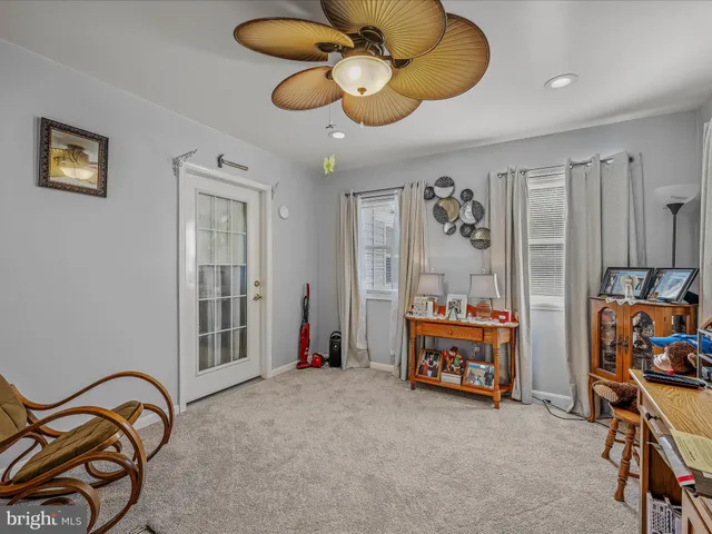 a living room with patio furniture and a chandelier