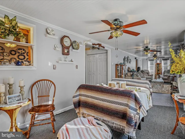a bedroom with a bed a dresser and a window