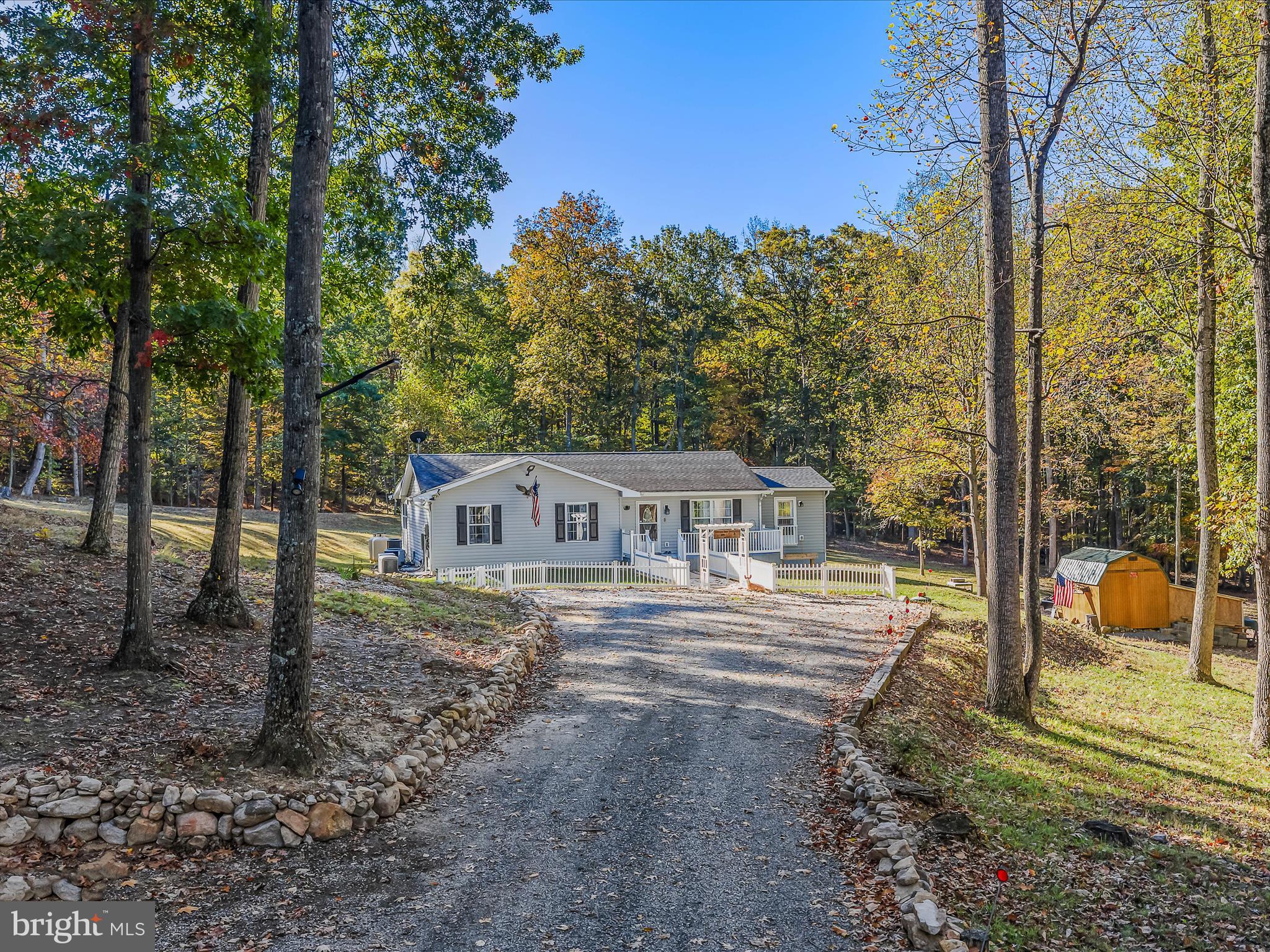 154 Brooklyn's Way Great Cacapon, WV 25422 - Photo 2 of 64 a front view of a house with garden