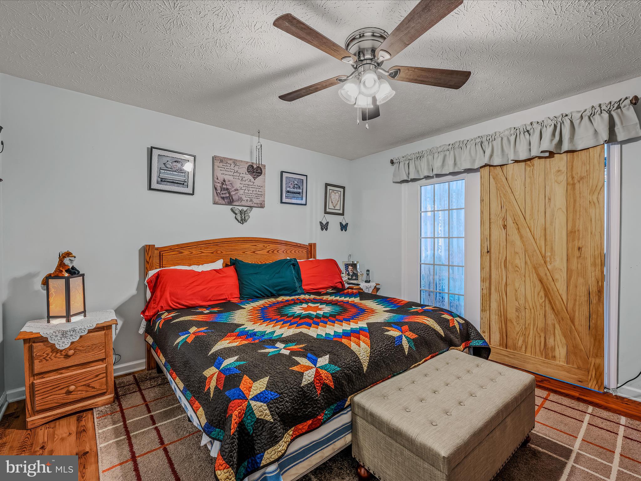 154 Brooklyn's Way Great Cacapon, WV 25422 - Photo 22 of 64 a bedroom with a bed a dresser and a window