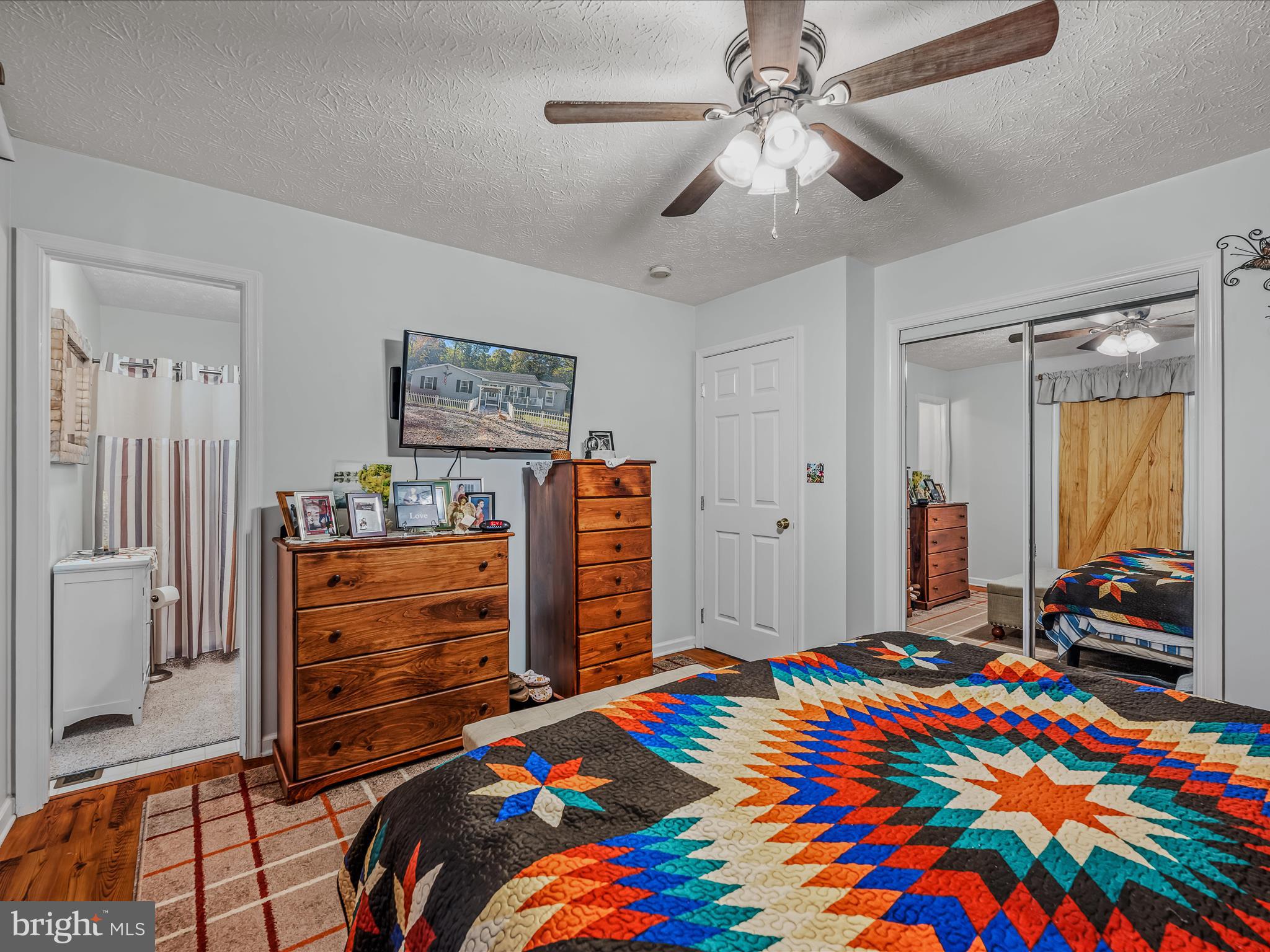 154 Brooklyn's Way Great Cacapon, WV 25422 - Photo 23 of 64 a bedroom with a bed and a chandelier