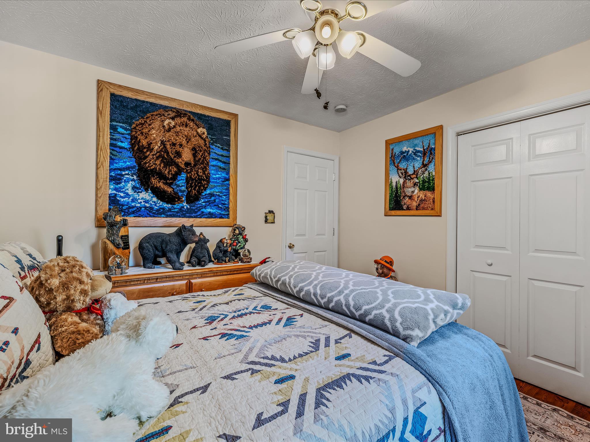 154 Brooklyn's Way Great Cacapon, WV 25422 - Photo 29 of 64 a bedroom with a bed and a chandelier