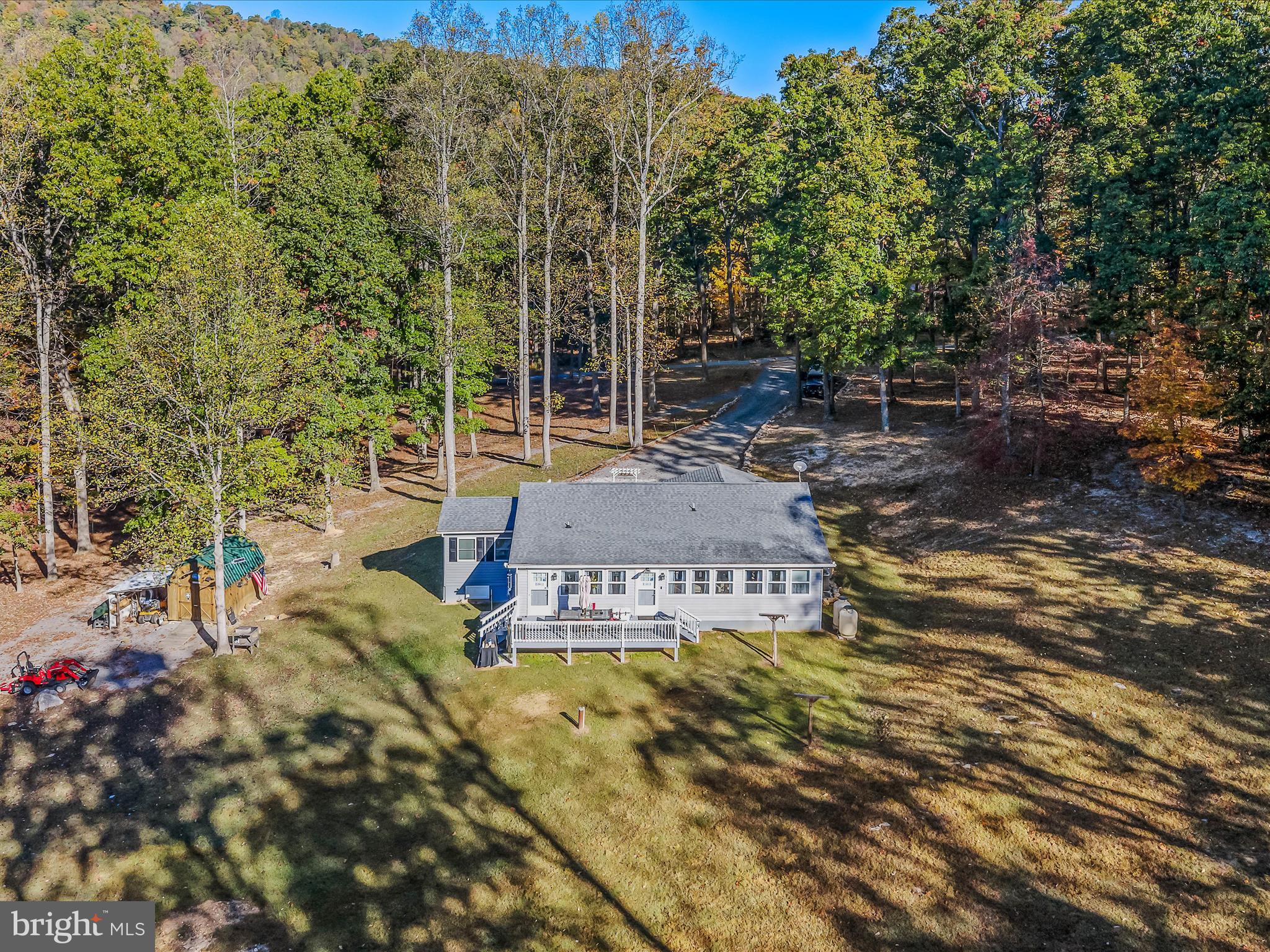 154 Brooklyn's Way Great Cacapon, WV 25422 - Photo 42 of 64 a view of a house with backyard and sitting area