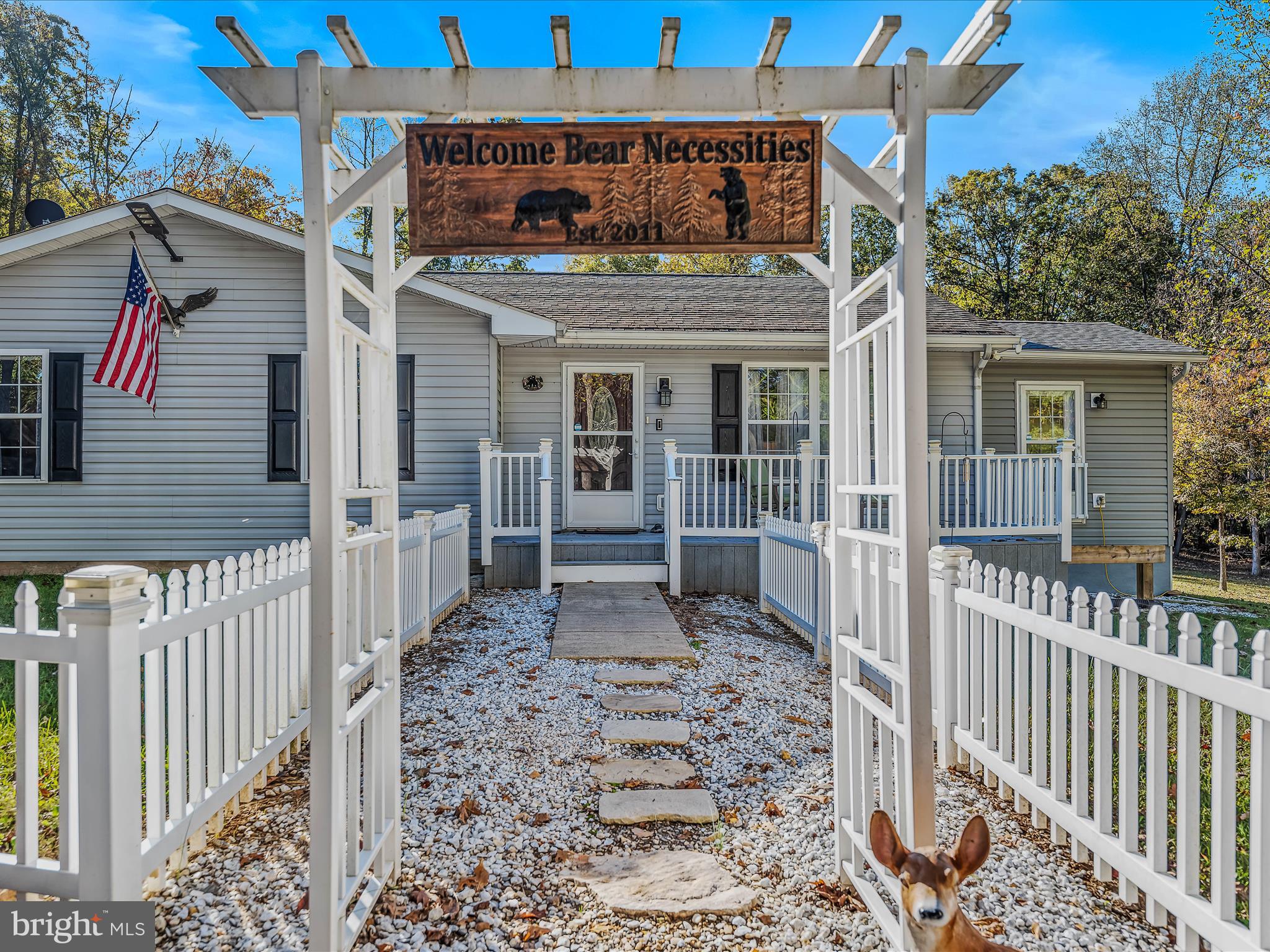 154 Brooklyn's Way Great Cacapon, WV 25422 - Photo 6 of 64 a view of a house with a small yard and wooden floor and fence