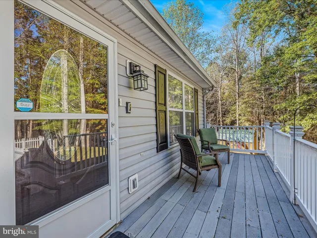 a view of deck with a large trees