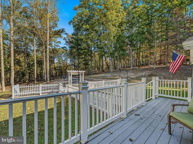 a living room with furniture ceiling fan and a window