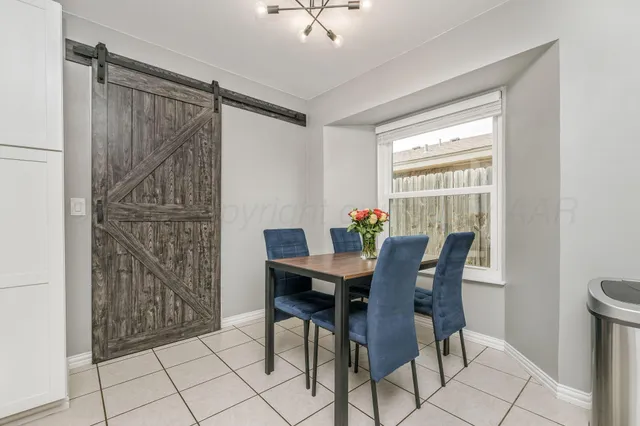 a view of a dining room with furniture and a window
