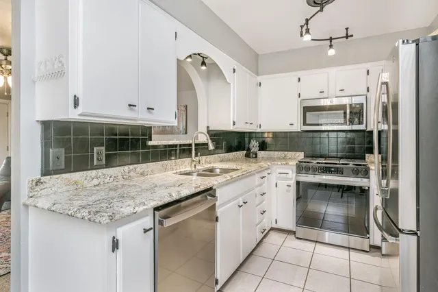 a kitchen with a sink stove and cabinets