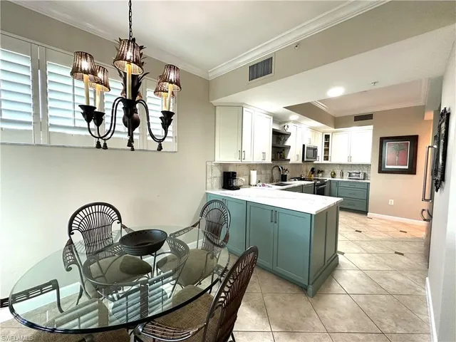 a living room with kitchen island furniture and a chandelier