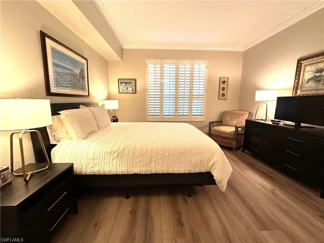 a bed room with a bed window and a television