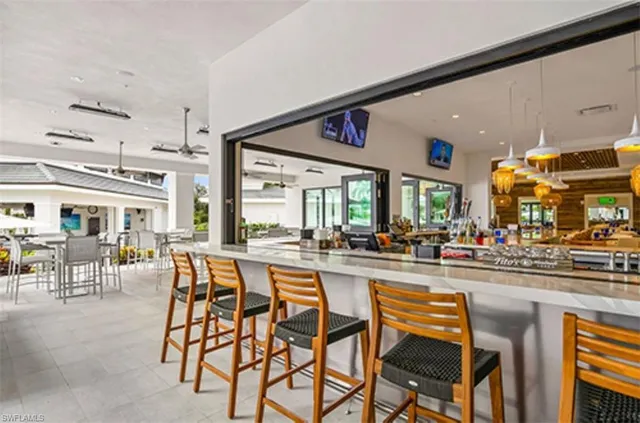 a dining area with furniture and a large window
