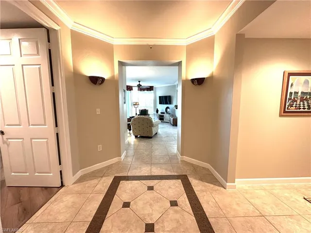a view of a hallway to a livingroom and a couch