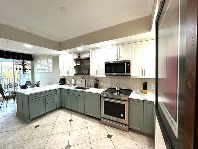 a kitchen with stainless steel appliances granite countertop a refrigerator a stove top oven a sink and dishwasher