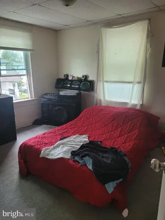 a bedroom with a bed and window