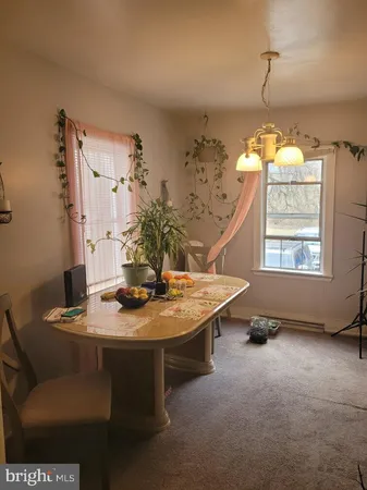 a dining room with furniture and window