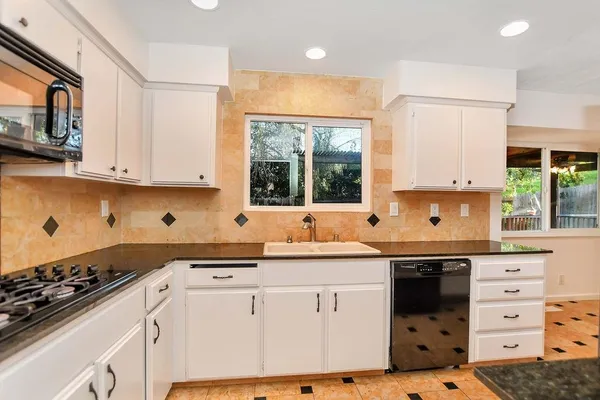 a kitchen with a sink stove and microwave