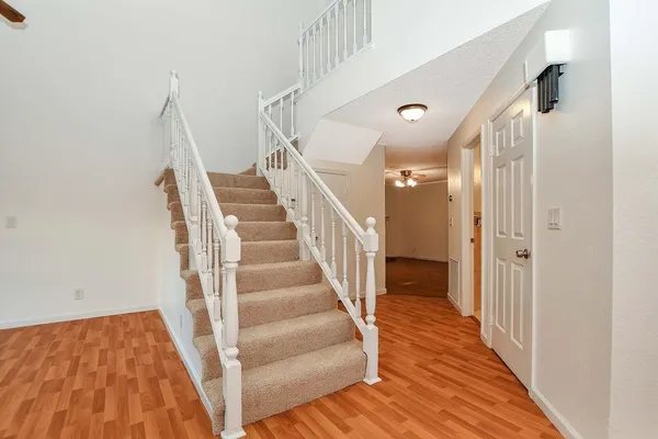 a view of entryway and hall with wooden floor