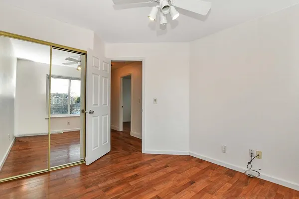 wooden floor in an empty room with a mirror
