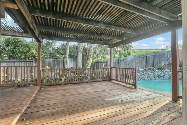 a view of a roof deck with wooden floor and fence