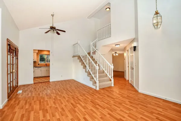 a view of empty room with wooden floor