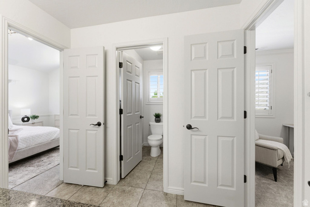 1712 Somerset Ridge Drive Draper, UT 84020 - Photo 43 of 76 White paneled interior doors with black hardware, tile flooring, and light-filled rooms with white walls and window shutters