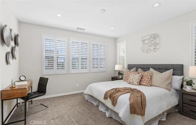 a bedroom with a bed and a desk