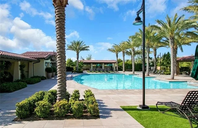a front view of a house with fountain and garden