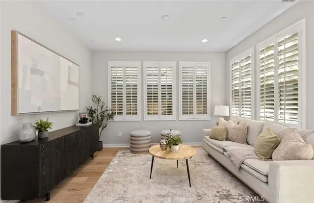 a living room with furniture and floor to ceiling windows