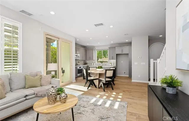 a living room with furniture potted plant and a large window