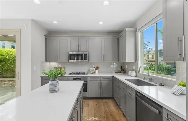 a kitchen with a sink a counter top space and cabinets
