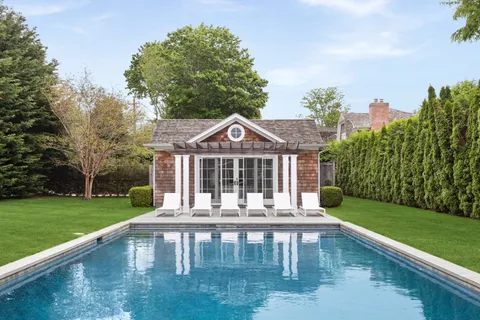 a front view of a house with garden yard and deck