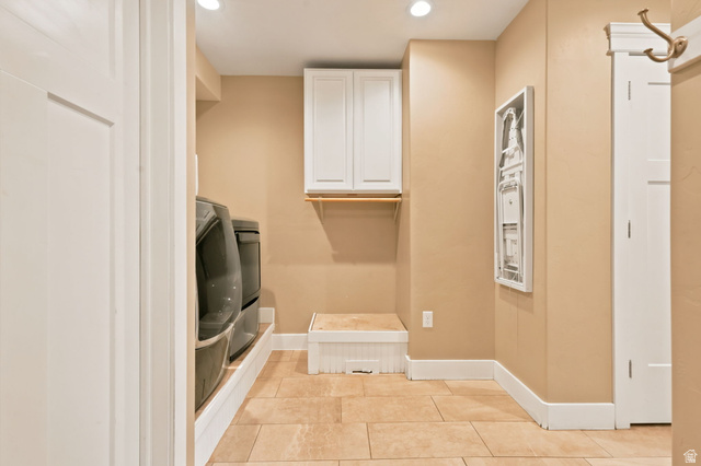 580 North 300 East Logan, UT 84321 - Photo 34 of 74 Utility space featuring tile flooring, recessed lighting, white cabinetry, and a wooden hanging rod