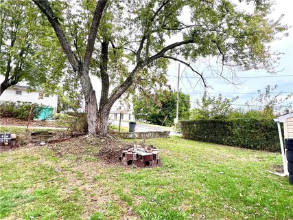 a view of backyard with table and chairs and couches