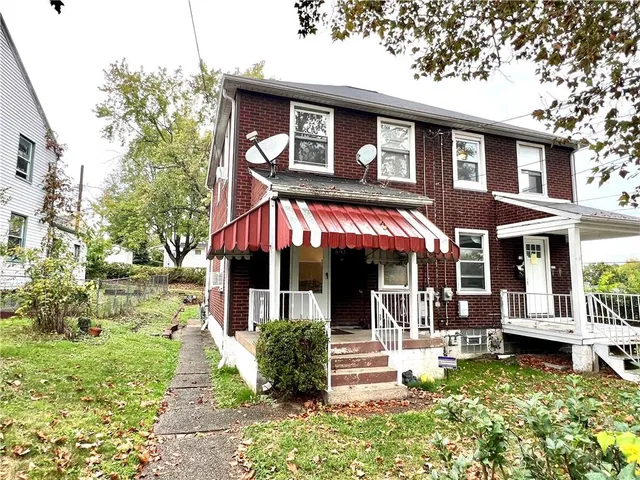 a front view of a house with a yard table and chairs
