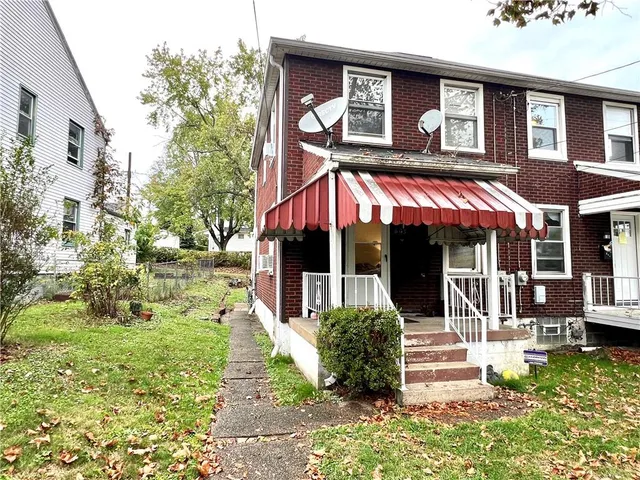 a view of a house with backyard porch and sitting area