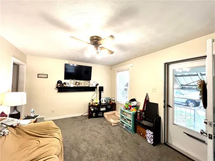 a bedroom with furniture and a flat screen tv