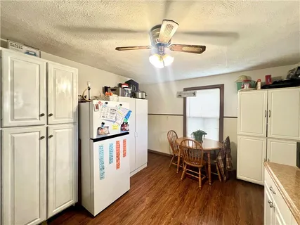 a view of a dining room with furniture a chandelier and wooden floor