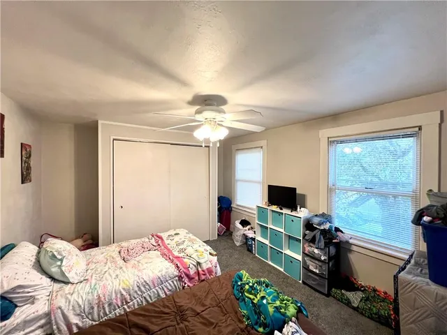 a bedroom with a bed and flat screen tv