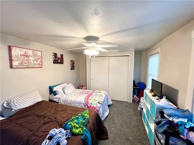 a bedroom with bed and a window