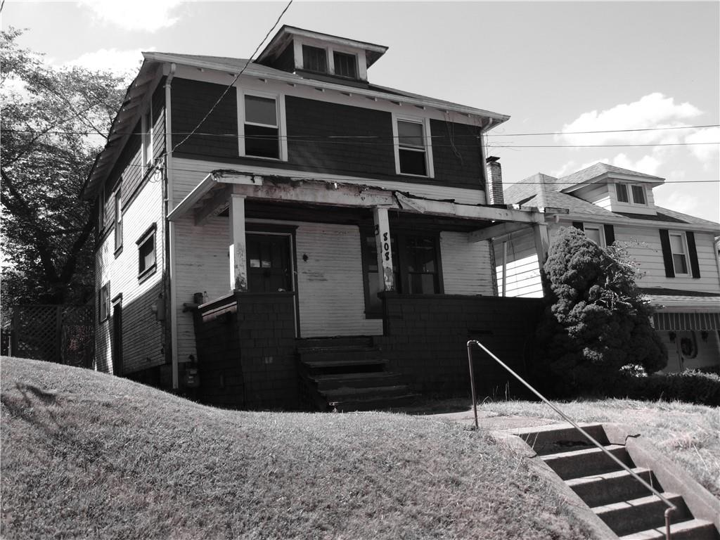 a black car parked in front of house