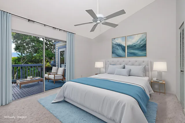 a bedroom with a large bed and a large window