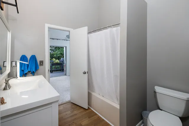 a bathroom with a sink a toilet and tub