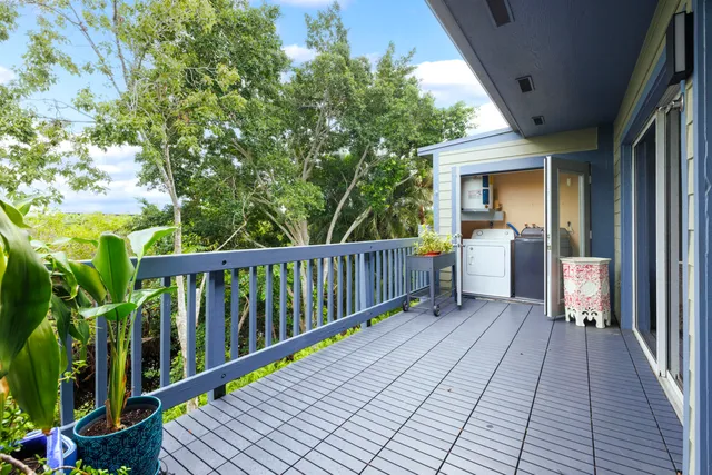 a view of balcony with wooden floor and fence