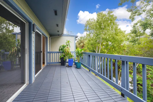 a view of a balcony with wooden floor