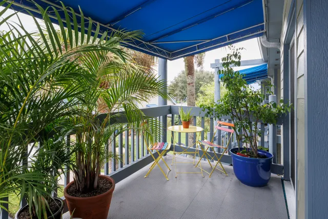 a view of a porch with potted plants